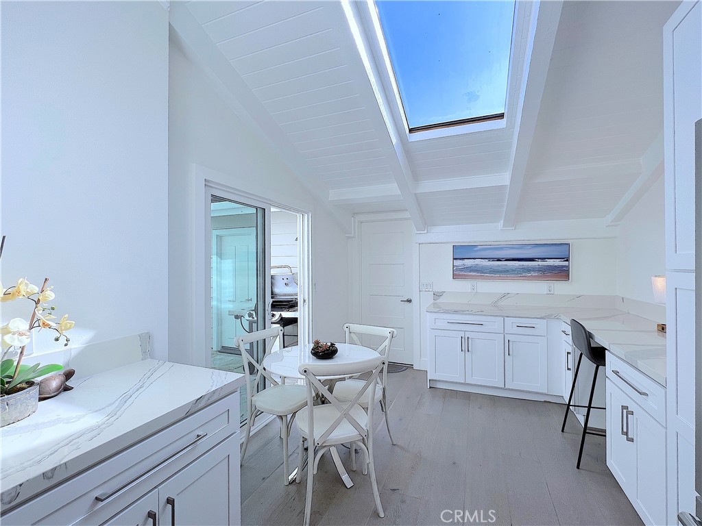 24105 Gourami Bay Dana Point, CA 92629 - Photo 28 of 56 a kitchen with a table chairs and white cabinets