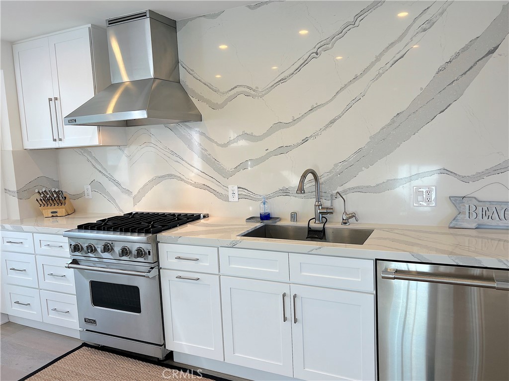 24105 Gourami Bay Dana Point, CA 92629 - Photo 34 of 56 a kitchen with stainless steel appliances a sink stove and cabinets