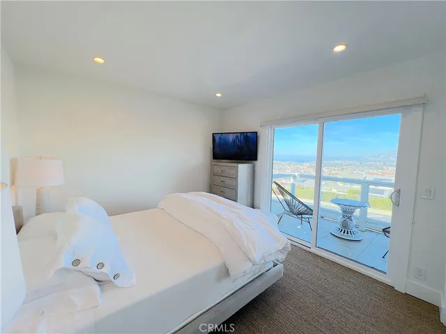 a large bed sitting in a bedroom and a table