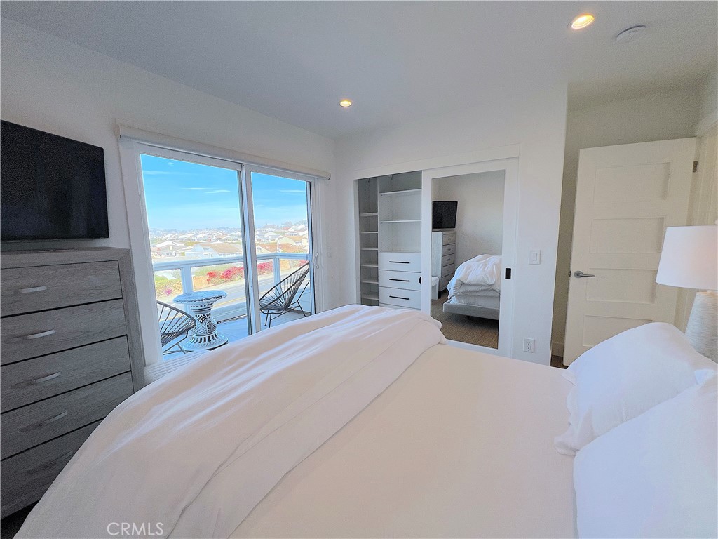 24105 Gourami Bay Dana Point, CA 92629 - Photo 49 of 56 a bedroom with a bed and a flat tv screen on dresser