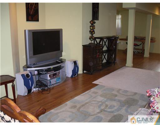 30 Carnation Road Monroe Township, NJ 08831 - Photo 17 of 20 a living room with furniture and a flat screen tv