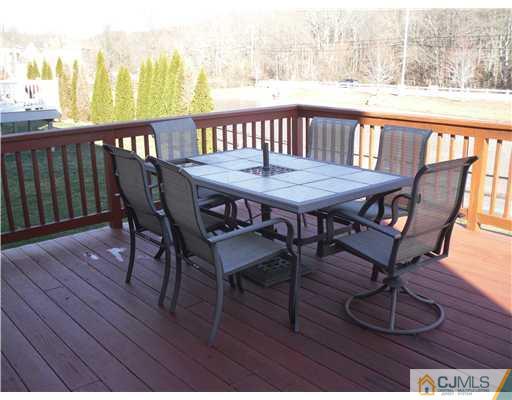 30 Carnation Road Monroe Township, NJ 08831 - Photo 18 of 20 a view of a balcony with furniture and wooden floor