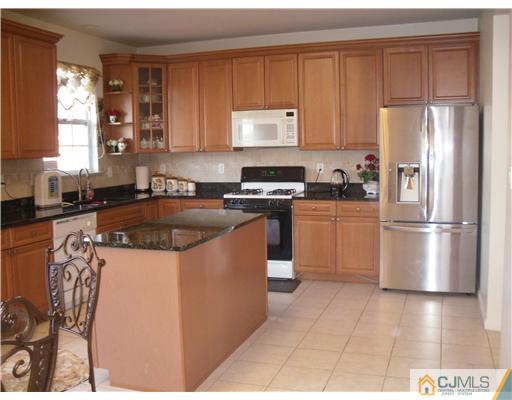 30 Carnation Road Monroe Township, NJ 08831 - Photo 5 of 20 a kitchen with stainless steel appliances granite countertop a stove a sink dishwasher a refrigerator and a microwave