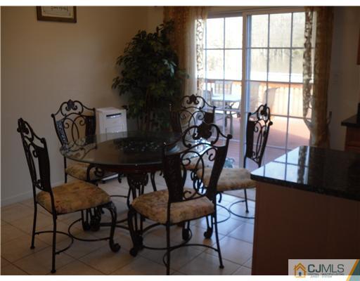 30 Carnation Road Monroe Township, NJ 08831 - Photo 6 of 20 a view of a dining room with furniture and a potted plant