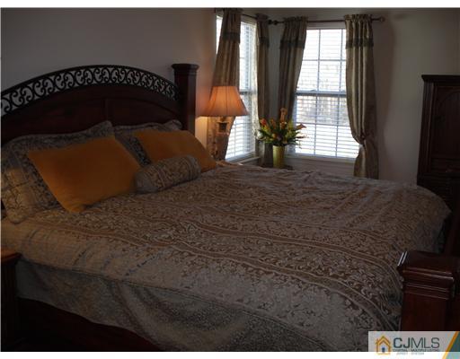 30 Carnation Road Monroe Township, NJ 08831 - Photo 7 of 20 a bed sitting in a bedroom next to a window