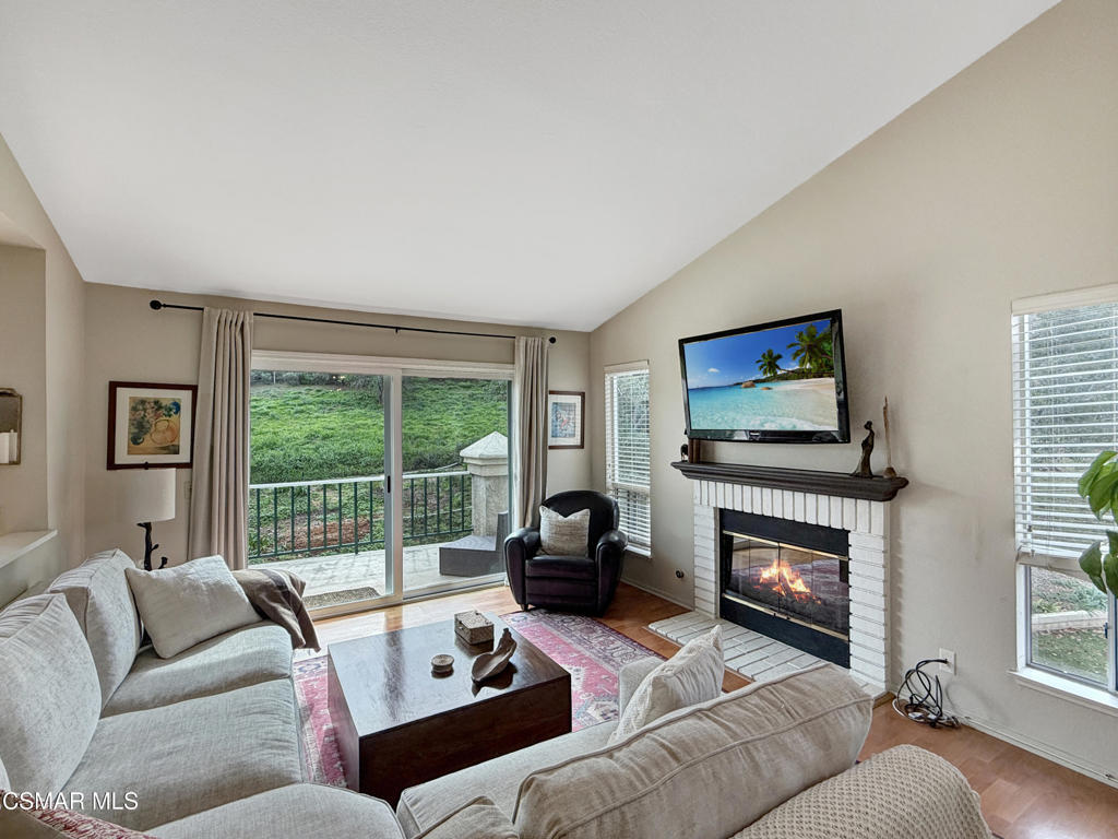 264 Ridgeton Lane, Unit B Simi Valley, CA 93065 - Photo 12 of 32 a living room with furniture a flat screen tv and a fireplace
