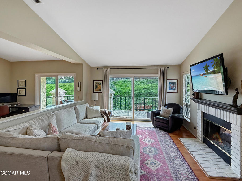264 Ridgeton Lane, Unit B Simi Valley, CA 93065 - Photo 13 of 32 a living room with furniture a flat screen tv and a fireplace