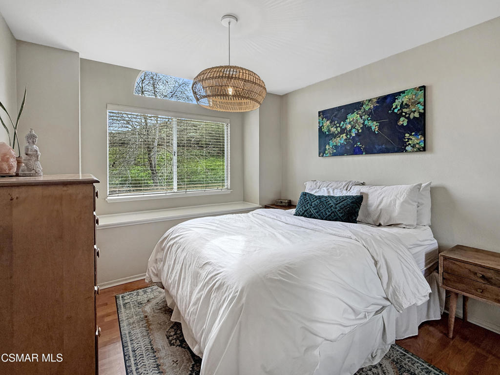 264 Ridgeton Lane, Unit B Simi Valley, CA 93065 - Photo 29 of 32 a bedroom with a bed and a window