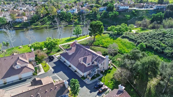 an aerial view of a house with garden space and lake view