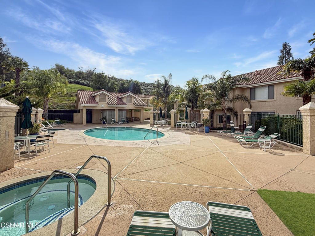 264 Ridgeton Lane, Unit B Simi Valley, CA 93065 - Photo 32 of 32 a view of a patio with table and chairs with wooden floor and fence