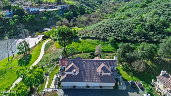 an aerial view of a house with a yard basket ball court and outdoor seating