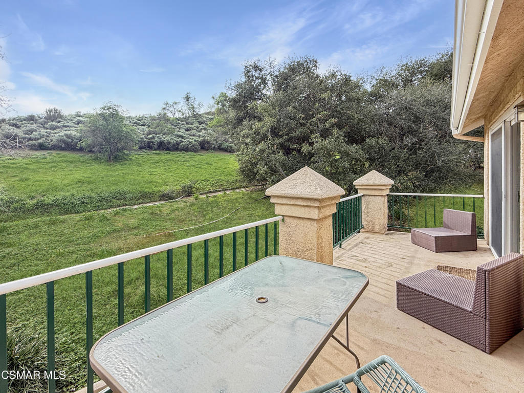 264 Ridgeton Lane, Unit B Simi Valley, CA 93065 - Photo 6 of 32 a view of a deck with a floor to ceiling window next to a yard