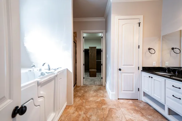 a bathroom with granite countertop a sink and a mirror