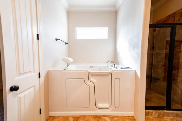 a large white kitchen with granite countertop a sink and a white cabinets