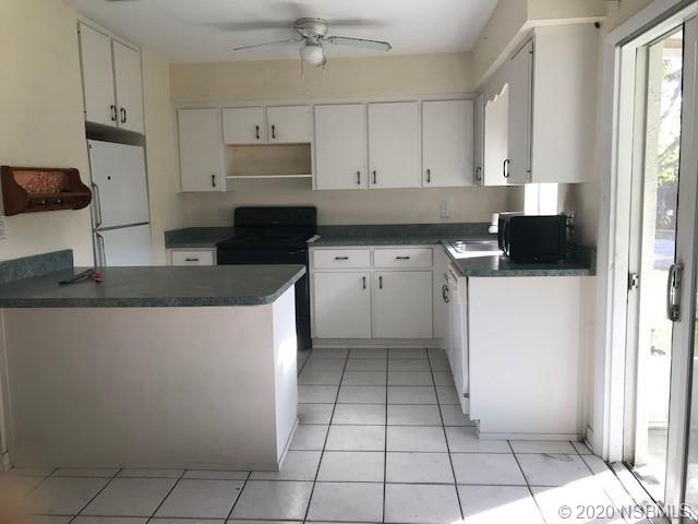 1600 Bradford Road Edgewater, FL 32132 - Photo 6 of 7 a kitchen with a sink a stove and cabinets