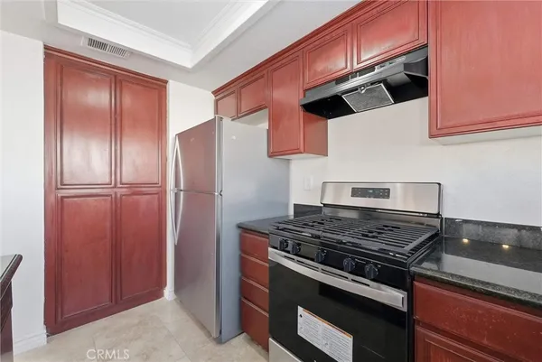 a kitchen with stainless steel appliances granite countertop a stove and a refrigerator