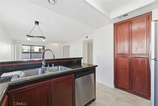 a kitchen with stainless steel appliances granite countertop a sink refrigerator and cabinets