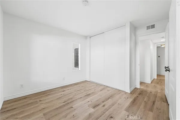 a view of a room with wooden floor and bathroom