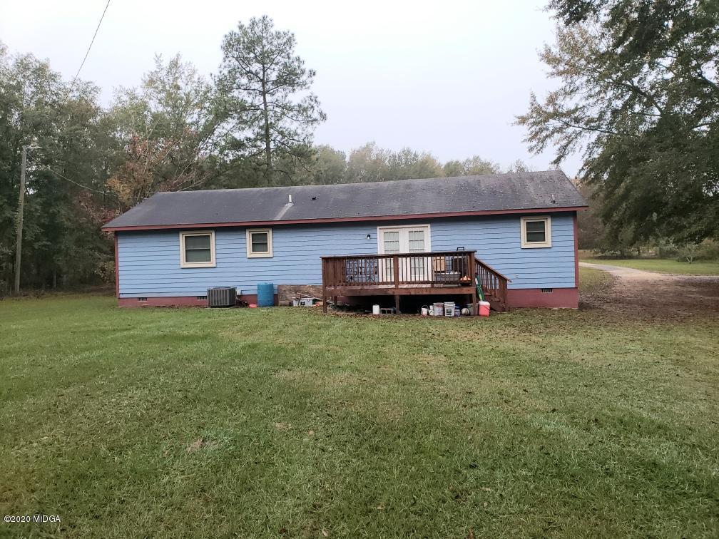 245 Pope Road Roberta, GA 31078 - Photo 2 of 8 a front view of a house with a garden and trees