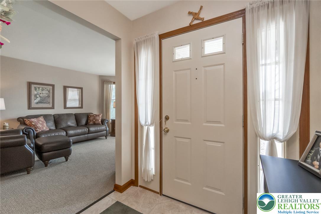 2298 Yost Road Bath, PA 18014 - Photo 14 of 33 A welcoming entry, complete with a paneled door, leads to a spacious living room.
