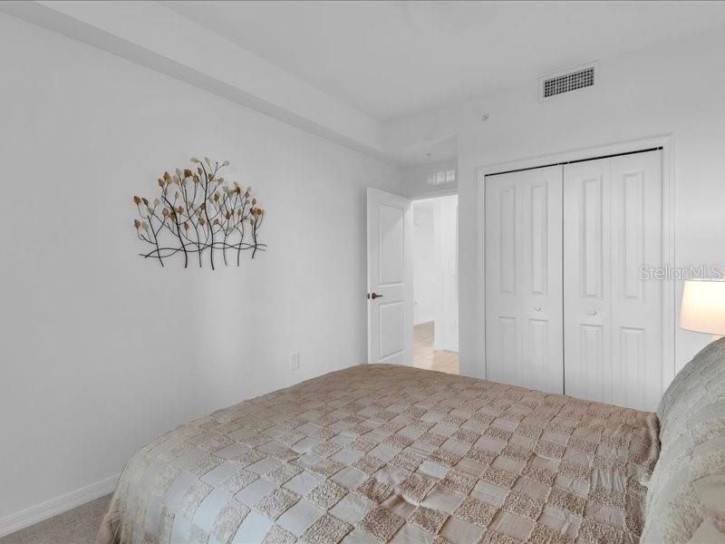 19116 Scallop Loop, Unit 303 Lakewood Ranch, FL 34211 - Photo 27 of 32 a bedroom with a bed and a chandelier