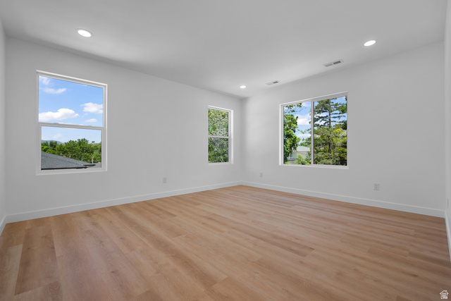 7238 South 525 East Midvale, UT 84047 - Photo 14 of 29 Spacious room featuring light wood-finish flooring, recessed lighting, and multiple windows