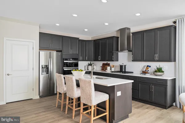 a kitchen with a sink a stove a refrigerator and cabinets