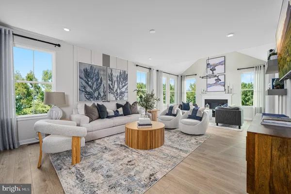 a living room with fireplace furniture and a wooden floor