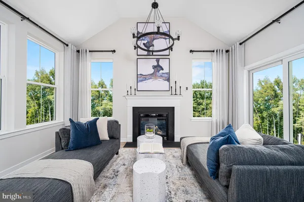 a living room with furniture a window and a fireplace