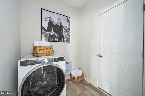 a view of a bathroom with washing machine and a view of bathroom