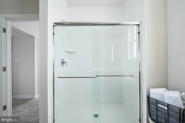 a bathroom with a glass shower door