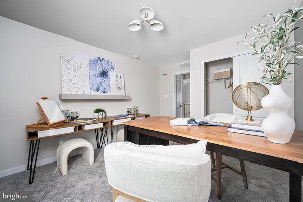 a view of a workspace with furniture and chandelier