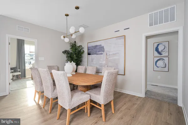 a dining room with furniture and wooden floor