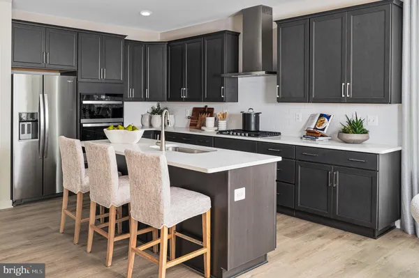 a kitchen with wooden cabinets and stainless steel appliances