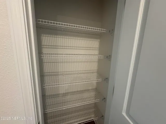 a large kitchen with kitchen island a sink stainless steel appliances and cabinets