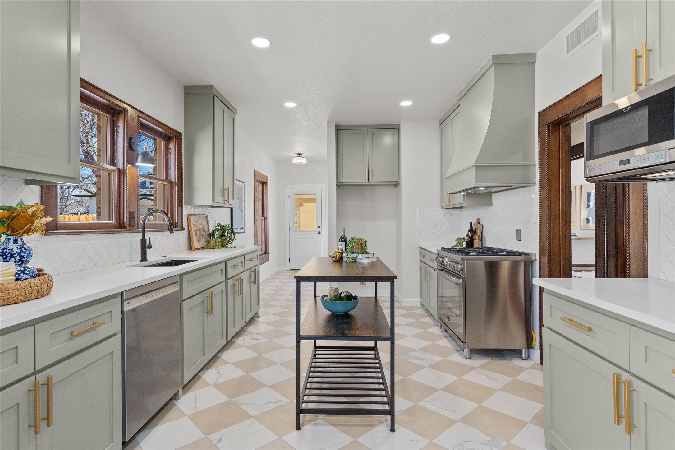 1605 South Austin Avenue Georgetown, TX 78626 - Photo 11 of 40 Kitchen featuring light flooring, healthy amount of natural light, stainless steel appliances, light stone counters, and recessed lighting