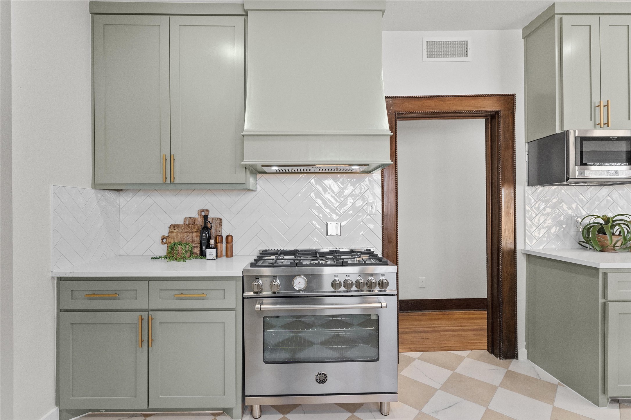 1605 South Austin Avenue Georgetown, TX 78626 - Photo 14 of 40 Kitchen with stainless steel appliances, gray cabinetry, light stone countertops, and light flooring