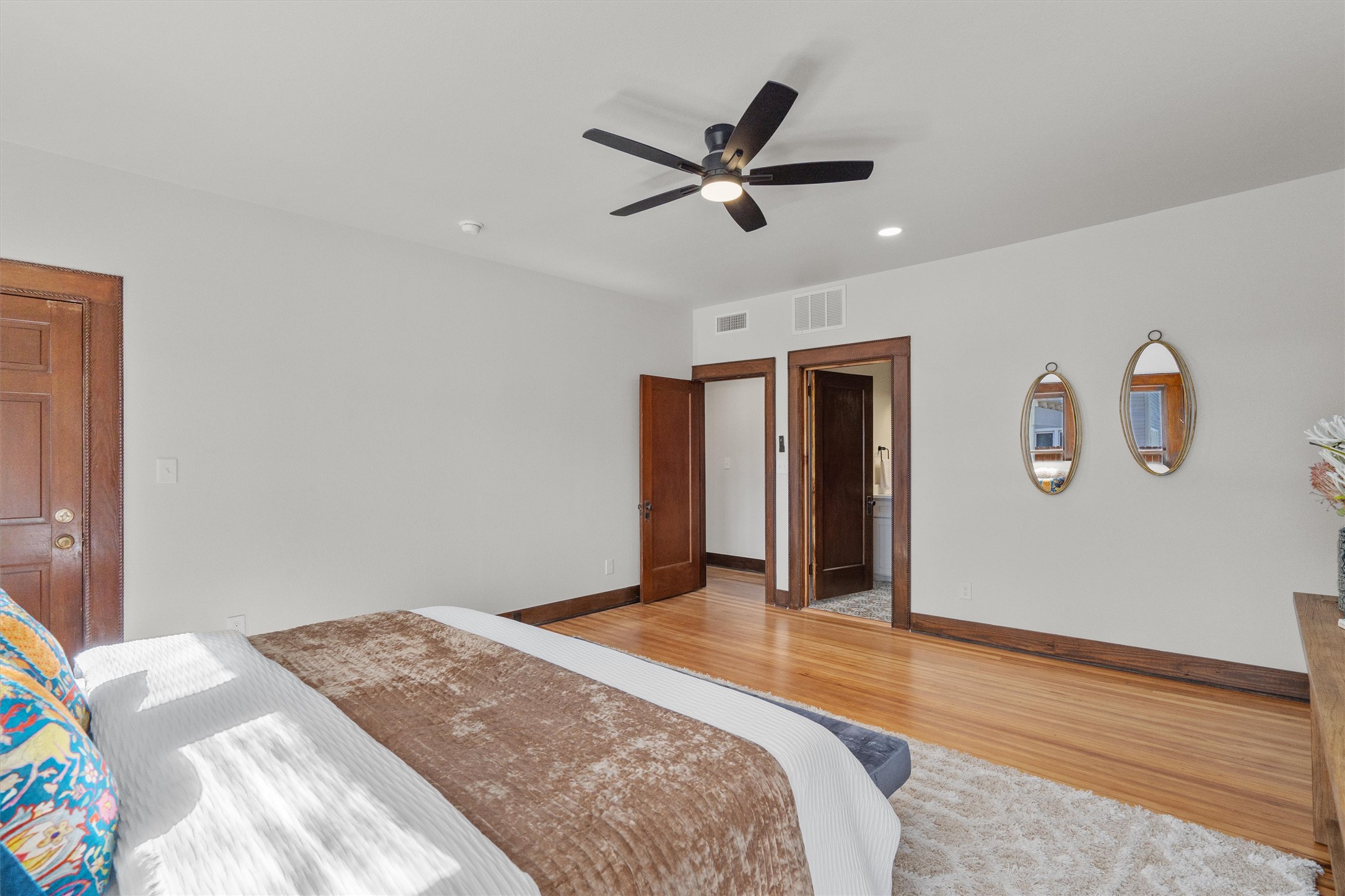 1605 South Austin Avenue Georgetown, TX 78626 - Photo 16 of 40 Bedroom featuring wood finished floors, a ceiling fan, and recessed lighting