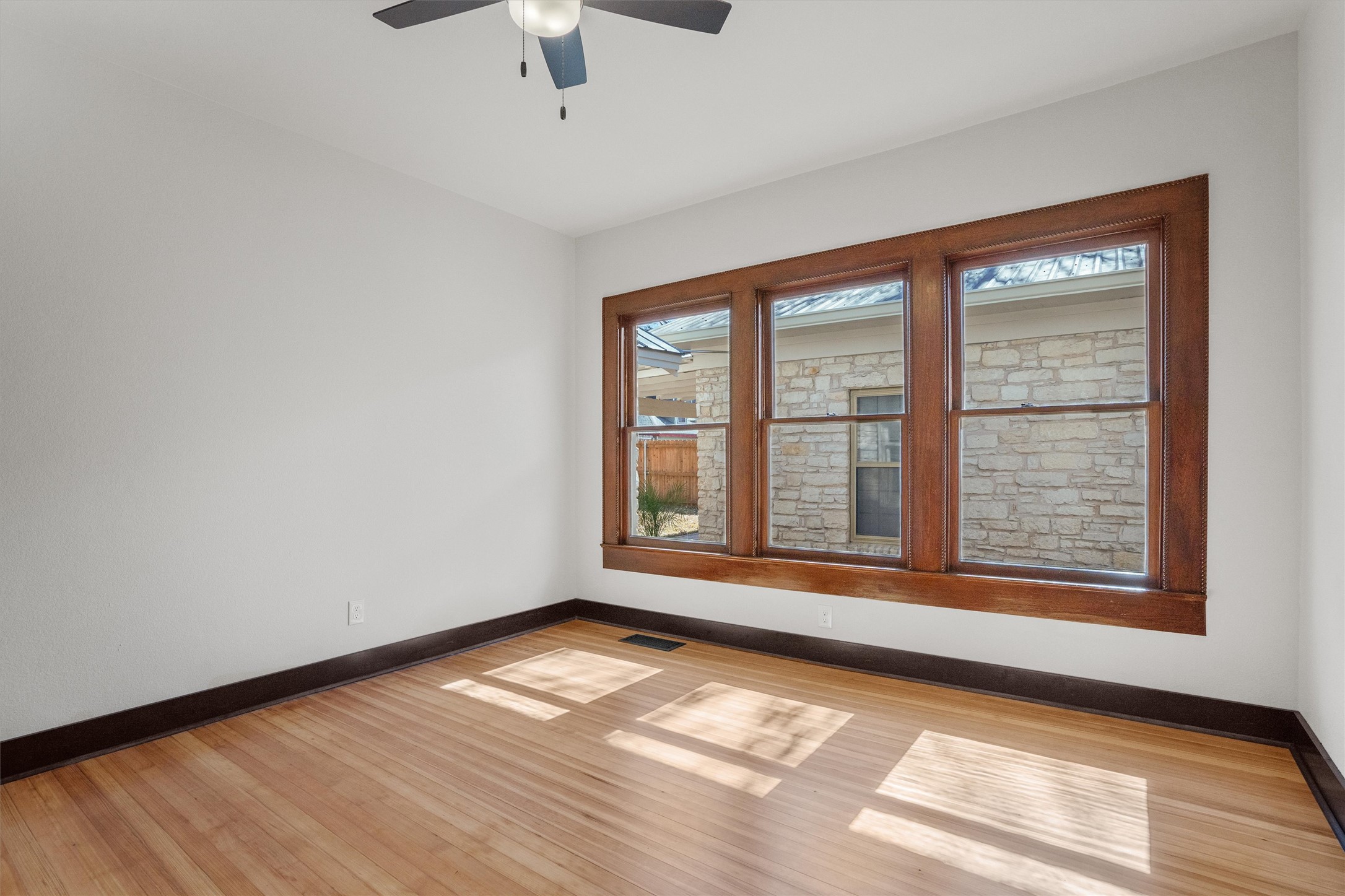 1605 South Austin Avenue Georgetown, TX 78626 - Photo 20 of 40 Unfurnished room featuring light wood-style floors and ceiling fan