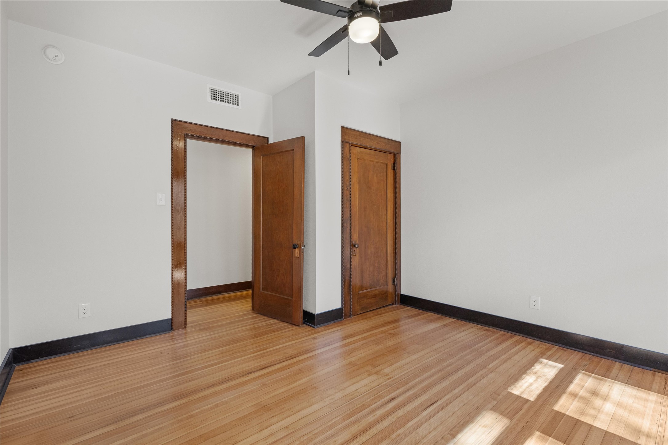 1605 South Austin Avenue Georgetown, TX 78626 - Photo 21 of 40 Unfurnished bedroom featuring light wood finished floors, a ceiling fan, and a closet