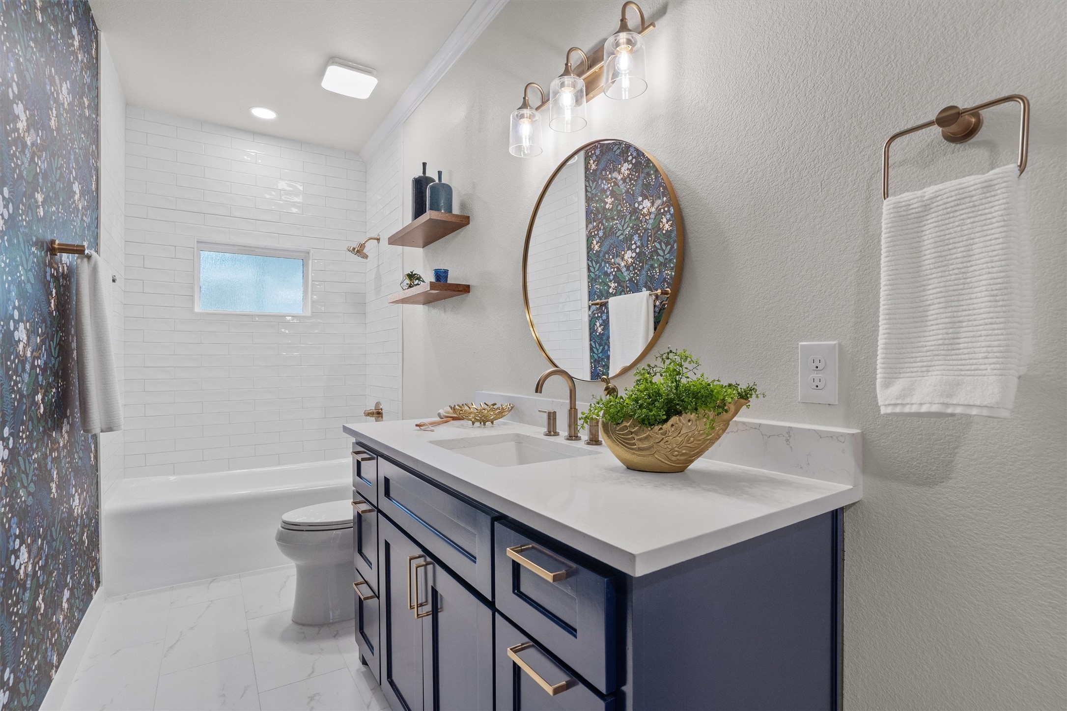 1605 South Austin Avenue Georgetown, TX 78626 - Photo 22 of 40 Bathroom featuring vanity, shower combination, a textured wall, ornamental molding, and light marble finish flooring