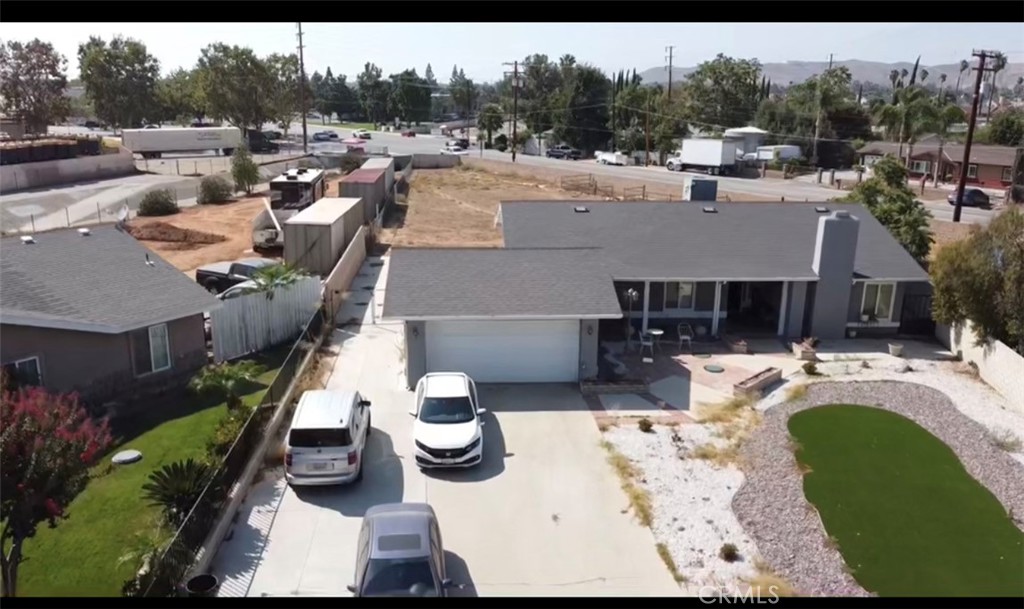 an aerial view of a house with swimming pool and outdoor seating