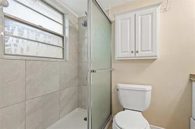a white toilet sitting next to a bathroom sink