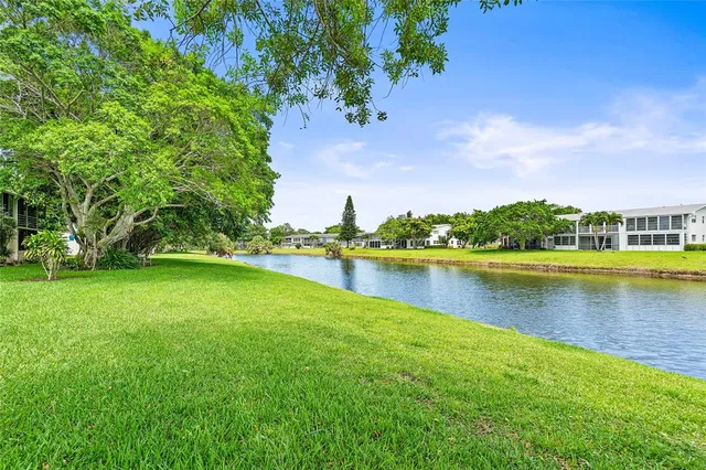 a view of a lake with houses in the back