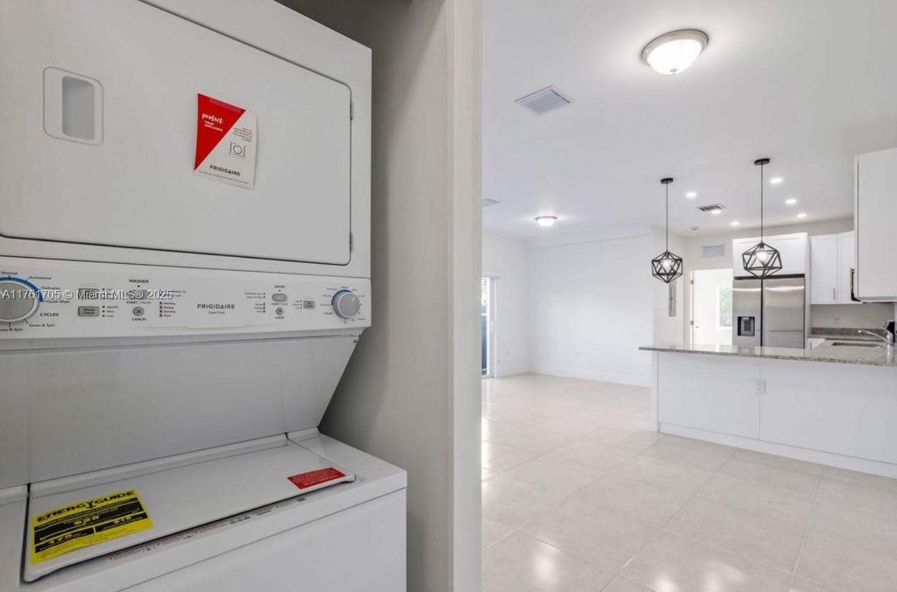 11240 Southwest 187th Street, Unit 11240 Miami, FL 33157 - Photo 6 of 9 a view of kitchen with stainless steel appliances cabinets and a kitchen view