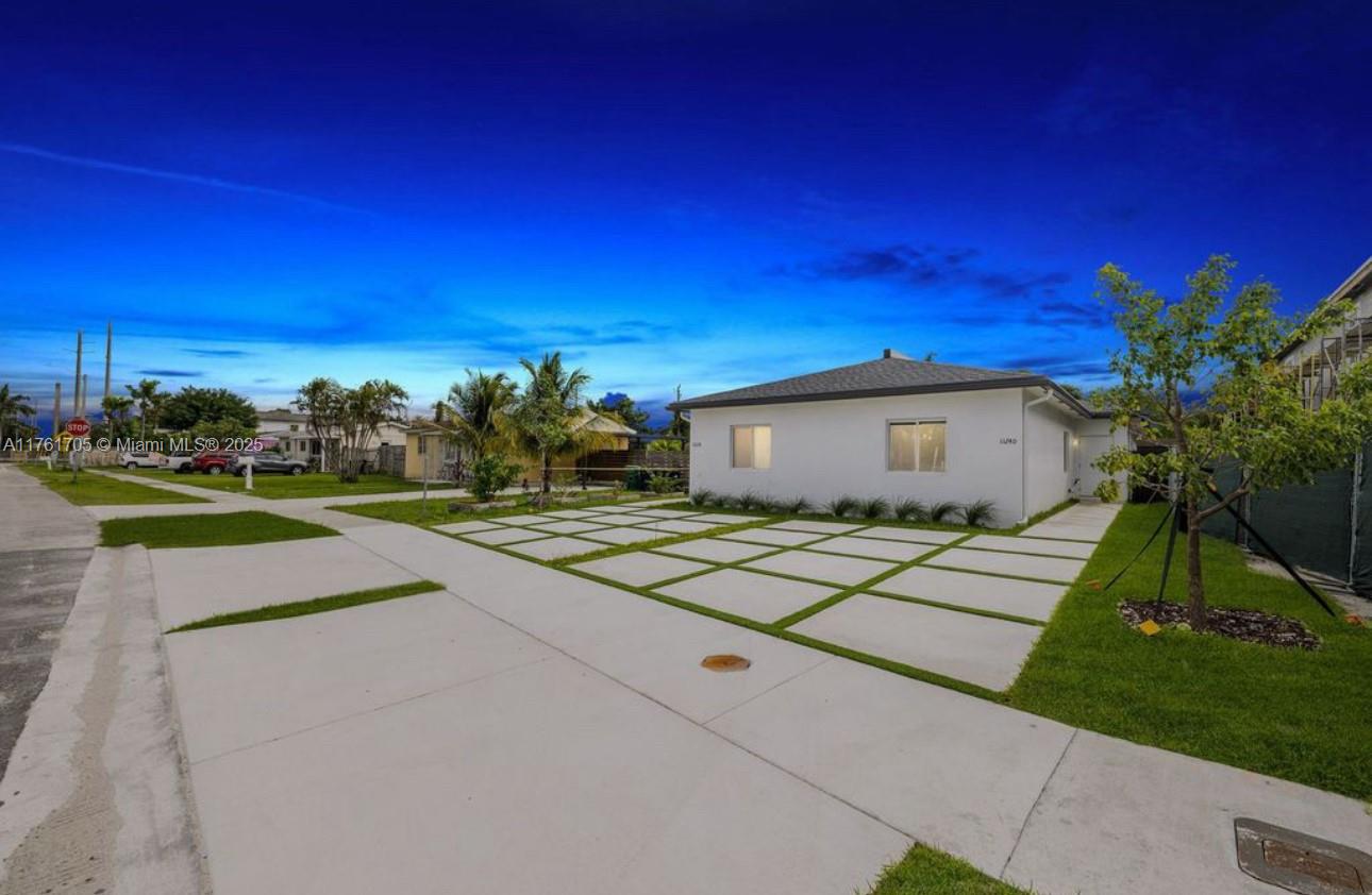 11240 Southwest 187th Street, Unit 11240 Miami, FL 33157 - Photo 9 of 9 a view of a house with a yard