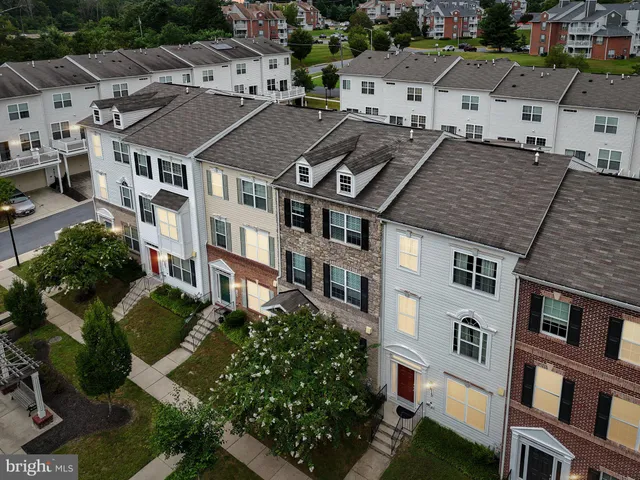 a front view of a residential apartment building with a yard
