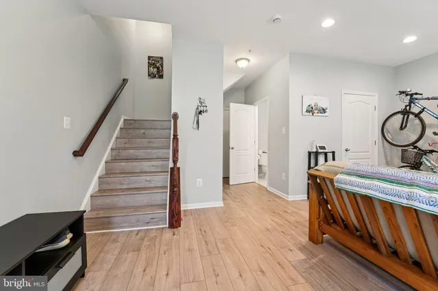 a living room with furniture and a flat screen tv with wooden floor