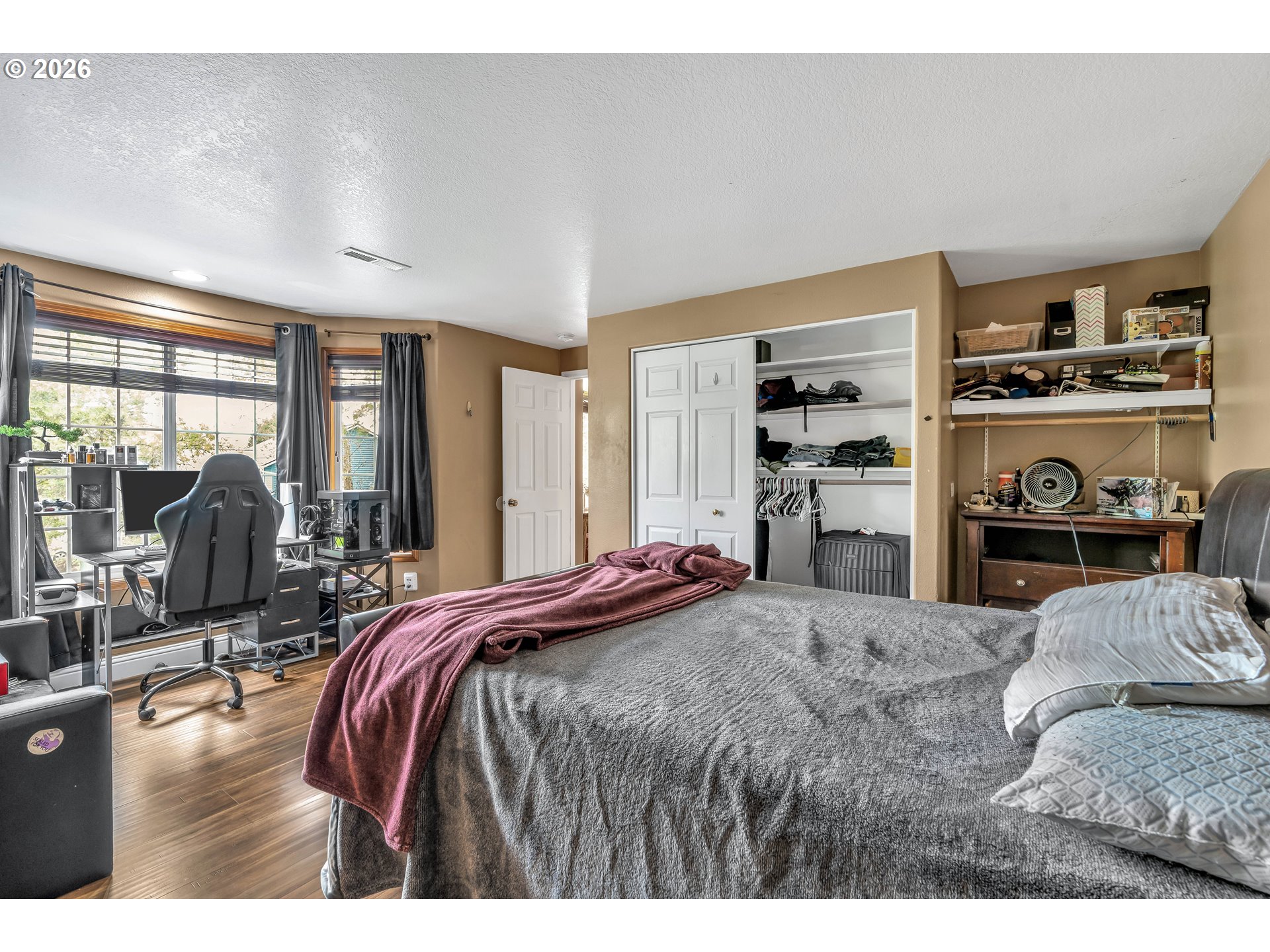 21498 Southwest Jay Street Beaverton, OR 97003 - Photo 29 of 47 a bedroom with a bed and wooden floor