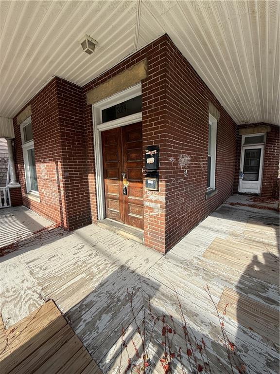 324 West New Castle Street Butler, PA 16001 - Photo 2 of 16 a view of a house with a barbeque and wooden stairs